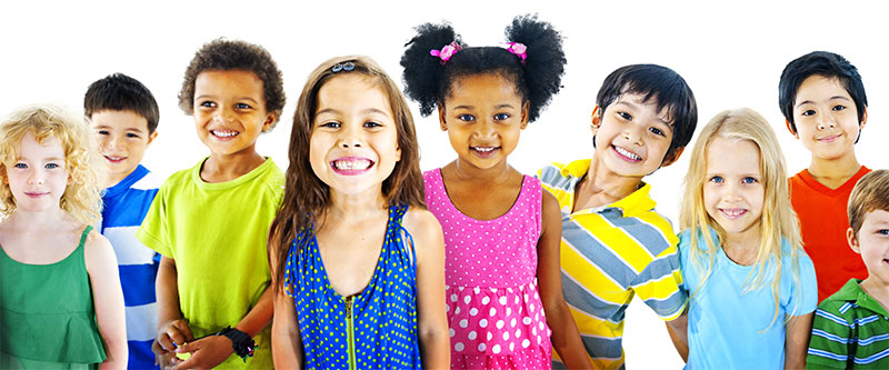 The image shows a diverse group of children and teenagers posing together for a photo with colorful clothing and a variety of expressions.